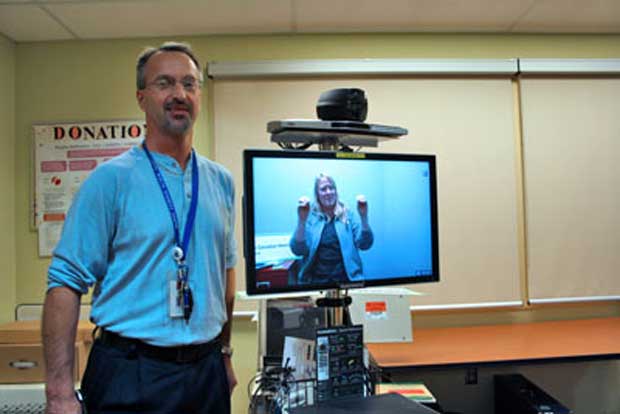 Bruce Bogacki (left) and Glenda Messier demonstrate the new wireless – and secure – videoconferencing equipment that will be used for American Sign Language interpretive services in the ICU and the Emergency Department