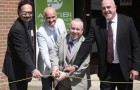 The team celebrates the grand opening with a ribbon cutting - Photo by Kevin Palmer