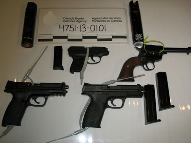 Four loaded handguns and two canisters of pepper spray seized from a traveller at the Pigeon River POE on August 12, 2013