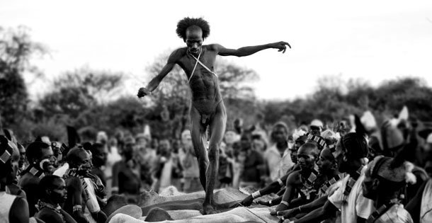 A Hamar man in Ethiopia's Lower Omo Valley has to jump over a line of cattle four times before getting married.