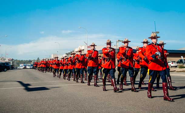 RCMP Officers march in Fort MacMurray during the Freedom of the City Centennial Event