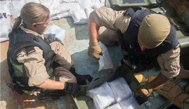 Boarding Party members of Her Majesty's Canadian Ship (HMCS) Toronto pack up seized narcotics after searching a suspected smuggling vessel in the Arabian Sea region on October 05, 2013. HMCS Toronto is currently deployed on Operation Artemis, the Canadian Armed Forces’ participation in maritime security and counter-terrorism operations in the Arabian Sea. HMCS Toronto’s task is to detect, deter and protect against terrorist activity by patrolling and conducting maritime security operations in her area of responsibility. This operation clearly demonstrates Canada’s solidarity with partners and allies as we continue to work together for peace and security in the maritime environment of the greater Middle East region. The Halifax-class frigate has a CH-124 Sea King helicopter air detachment as well as a shipboard unmanned aerial vehicle detachment. Photo Credit: Leading Seaman Dan Bard, Formation Imaging Services, Halifax, Nova Scotia ©