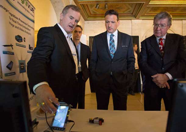 Minister of State for Science and Technology Greg Rickford and NRC President John McDougall watch a demonstration of an innovative technology developed by NRC-IRAP client Cognivue.