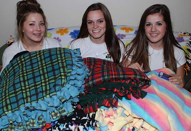 the blanket makers, from left to right, Shaniah McCraw, Lexi Adduono, and Kim Commisso. Missing from the photo are Jessie Micklea and Montana Russo.