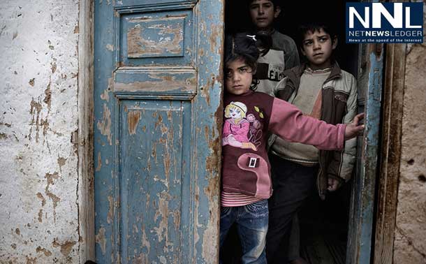 Syrian children shelter in the doorway of a house, amid gunfire and shelling, in a city affected by the conflict. Photo: UNICEF/NYHQ2012-0218/Alessio Romenzi