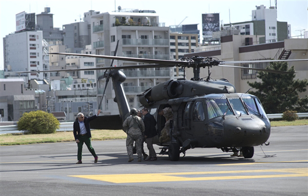 Secretary of Defense Chuck Hagel waves to the pilots of a UH-60 Blackhawk helicopter after landing at Hardy Barracks in Tokyo, April 5, 2014. Hagel met with troops at Yokota Air Base earlier in the day and will continue his 3-day stay in Japan, meeting with the Japanese prime minister and the defense and foreign ministers. DOD Photo by Erin A. Kirk-Cuomo 