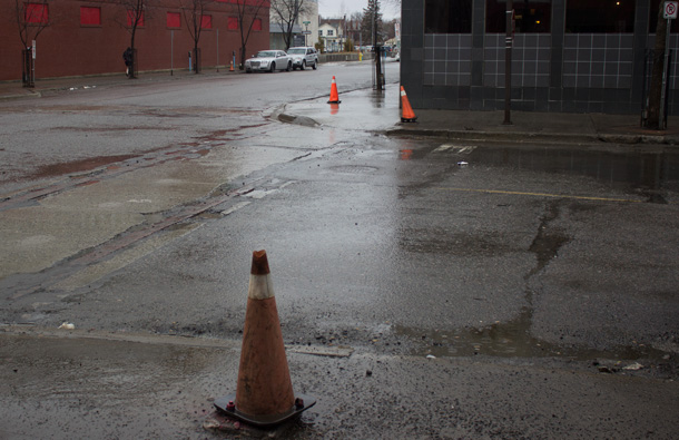 Orange cones where rusted out street posts once stood in downtown Fort William Business District.