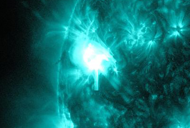 The bright light on the left side of the sun shows an M5.2-class solar flare in progress on May 8, 2014.This image, captured by NASA's SDO, shows light with a 131 Angstrom wavelength, which highlights the extremely hot material in a solar flare and is typically colorized in teal. Credit: NASA/SDO