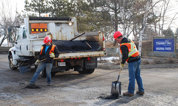 Fixing the potholes at Marina Park. The parking lot has been like a minefield for vehicles for the past year.