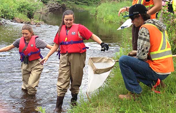 Stewardship Youth Rangers Gabrielle Gagnon (left), Jenna Langlais and Burt Buckley Collect Data and Clean Up the McIntyre River