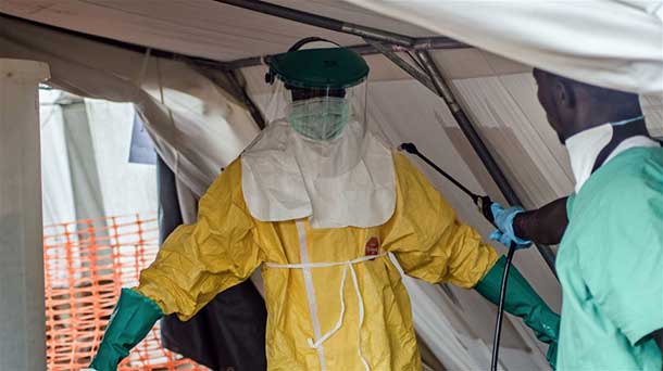 A Médecins Sans Frontières (MSF) health worker donning a protective suit to treat Ebola victims in Kailahun, Sierra Leone. Photo: IRIN/Tommy Trenchard