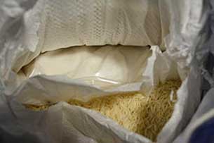 A sack of rice also containing a white powder (illicit drug) - RCMP Image
