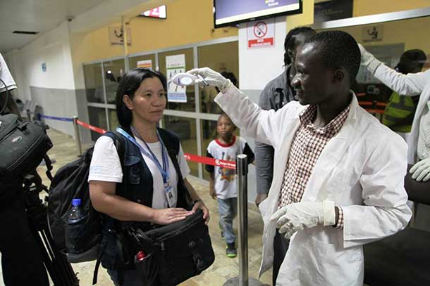 A WHO staff gets her body temperature checked at Lungi Airport, Freetown, Sierra Leone. Photo: WHO Sierra Leone