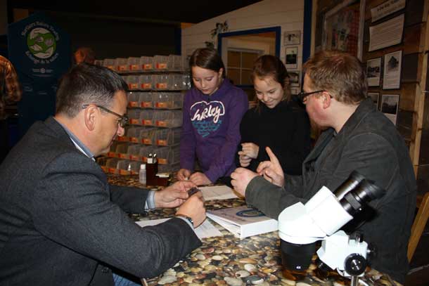 The Honourable Greg Rickford, Canada's Minister of Natural Resources and Minister for the Federal Economic Development Initiative for Northern Ontario (FedNor), and students from St. John's Separate School discover more about the Red Lake Northern Nature Trading experience with Trevor Osmond, Educational Programming Coordinator for Red Lake Regional Heritage Centre.