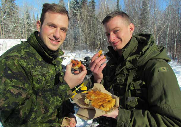 Corporals Nick DeSantis, of Stoney Creek, and Peter Albers, of St.Catharines, try eating their first bannock, an Aboriginal type of home made bread