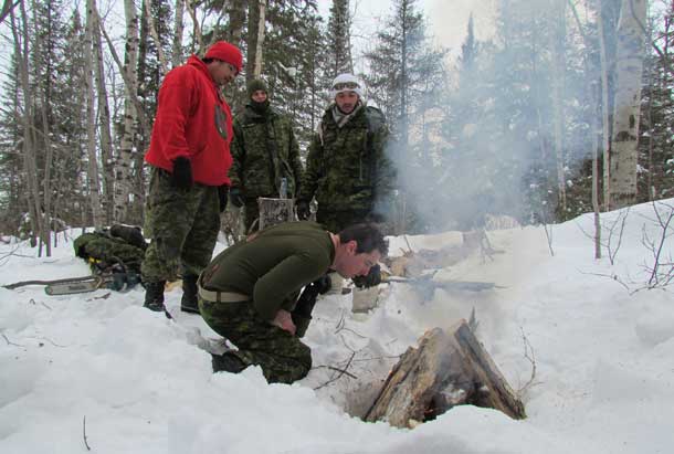 Ranger Master Corporal Peter Goodman teaches fire lighting techniques to reserve soldiers