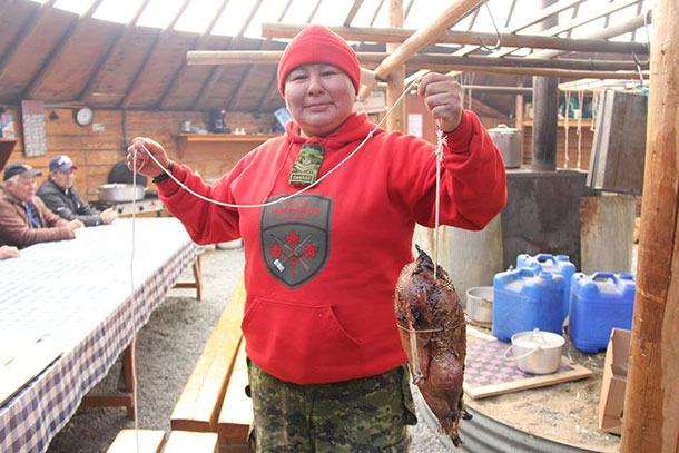 Master Corporal Yvonne Sutherland of Kashechewan helps prepare a goose for a feast in Waskaganish - Photo: Canadian Rangers