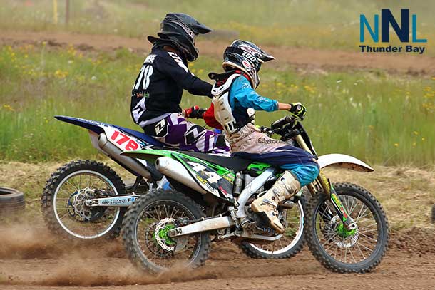 Collin Maronese (178) battles Scott Francis (44) for the lead heading into the first turn of their MX3 class race - Photo by Guy Gascoigne
