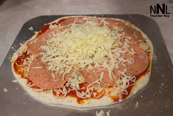 If you make your pizza on a pizza paddle, it is easy to slide it right onto a hot tile.