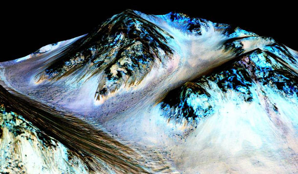 These dark, narrow, 100 meter-long streaks called recurring slope lineae flowing downhill on Mars are inferred to have been formed by contemporary flowing water. Recently, planetary scientists detected hydrated salts on these slopes at Hale crater, corroborating their original hypothesis that the streaks are indeed formed by liquid water. The blue color seen upslope of the dark streaks are thought not to be related to their formation, but instead are from the presence of the mineral pyroxene. The image is produced by draping an orthorectified (Infrared-Red-Blue/Green(IRB)) false color image (ESP_030570_1440) on a Digital Terrain Model (DTM) of the same site produced by High Resolution Imaging Science Experiment (University of Arizona). Vertical exaggeration is 1.5. Credits: NASA/JPL/University of Arizona