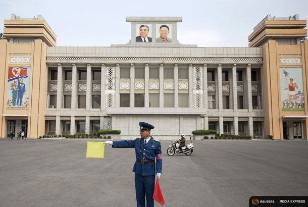 A policeman directs traffic at the Kim Il Sung Stadium before North Korea's preliminary 2018 World Cup and 2019 AFC Asian Cup qualifying soccer match against Philippines in Pyongyang, October 8, 2015. REUTERS/Damir Sagolj