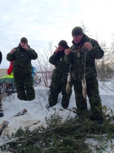 From left to right: Brigadier General Lowell Thomas 4 Div Commander, Chief Warrant Officer Stan Stapleford and Chief Warrant Officer Alain Guimond. On March 13, 2015 we take a tour of the old radar Site 500 near Winisk. The group stopped to enjoy some caribou ribs cooked over the fire for lunch.