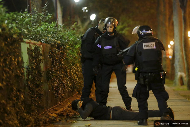 A man lies on the ground as French police check his identity near the Bataclan concert hall following fatal shootings in Paris, France, November 13, 2015. The man was later released after his identity was verified.    REUTERS/Christian Hartmann