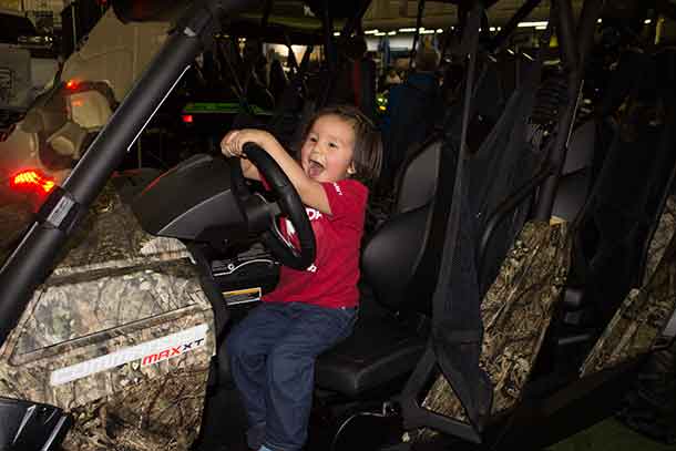 The smiles were huge as this young person enjoyed some imaginary off-roading at the Gordon Trailer Sales booth