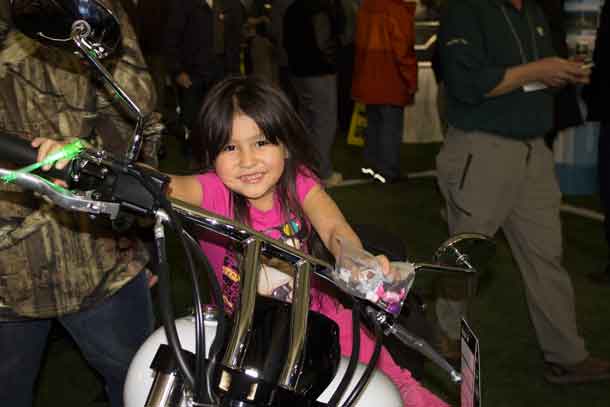 More huge smiles. Candy and a motorbike... what more might a girl want?