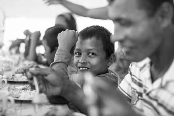 Together with his father, siblings and cousins, this young Colombian refugee gets a taste of home from his aunt’s cooking. Credit: Copyright 2016 Chris Terry