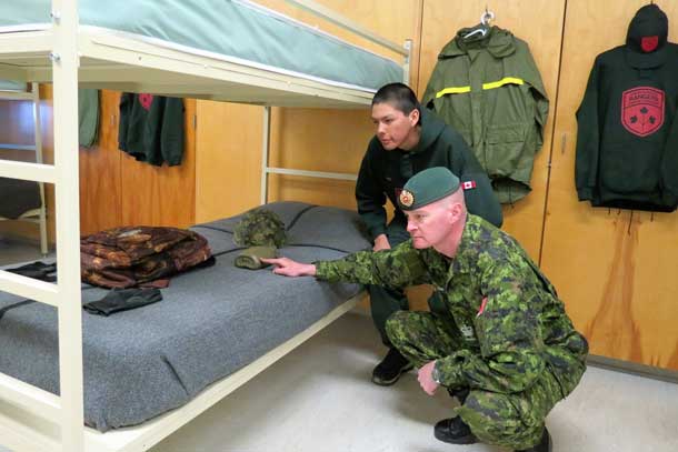Warrant Officer Ron Wen checks the bed space of Junior Canadian Ranger Jack Linklater of Attawapiskat