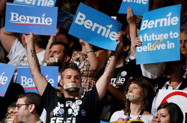 Supporters of Former Democratic presidential candidate Senator Bernie Sanders (D-VT) wear tape over their mouths at the Democratic National Convention in Philadelphia, Pennsylvania, U.S. July 25, 2016. REUTERS/Lucy Nicholson
