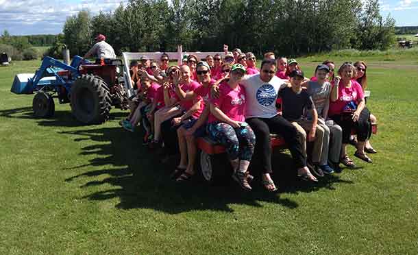 Campers and their companions enjoying a hayride at Camp Quality