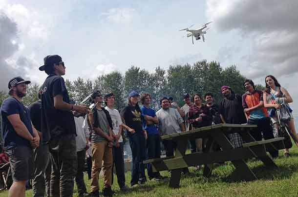 Participant Antoine Boyce (second from left) of Fort Hope First Nation flies a drone during Science Week, part of the First Nations Youth Employment Programs offered in partnership with Outland, Confederation College and Lakehead University