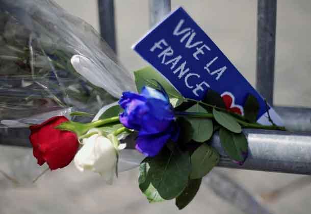 Flowers are seen attached to a fence to remember the victims of the Bastille Day truck attack in Nice in front of the French embassy in Rome, Italy, July 15, 2016. REUTERS/Max Rossi