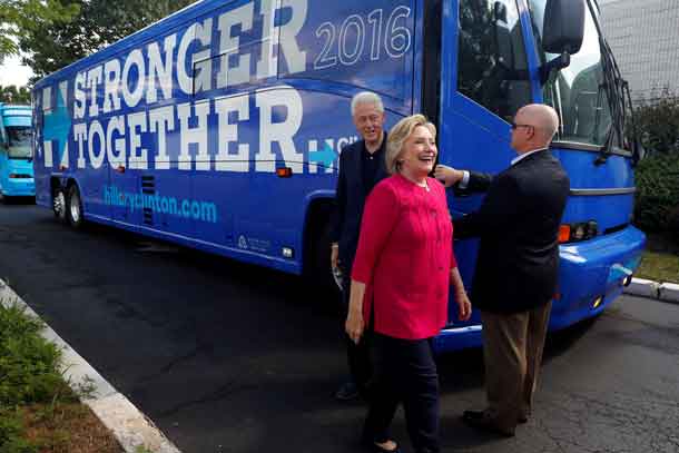 Democratic presidential candidate Hillary Clinton departs her bus with former president Bill Clinton at K'NEX in Hatfield, Pennsylvania, July 29, 2016.  REUTERS/Aaron P. Bernstein