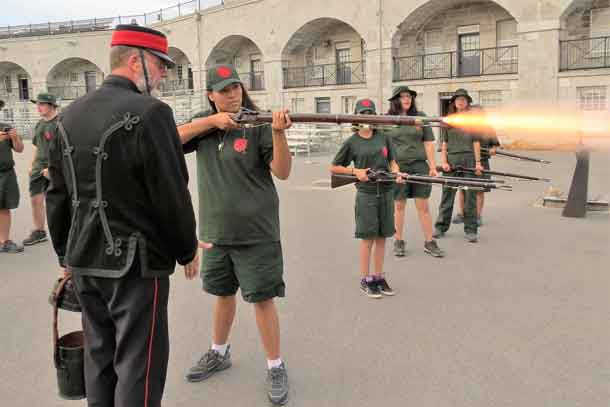Junior Canadian Ranger Kirsten Fiddler, 16, of Sandy Lake fires an 1867 British Army rifle at Old Fort Henry in Kingston.
