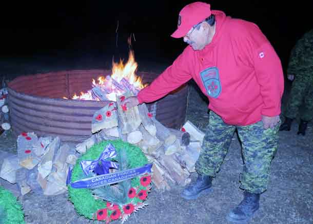 Master Corporal Albert Sutherland of Constance Lake lays his Poppy at the side of the ceremonial fire
