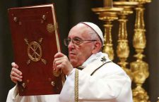 Pope Francis holds the book of the gospels as he leads the Christmas night Mass in Saint Peter's Basilica at the Vatican December 24, 2016. REUTERS/Tony Gentile