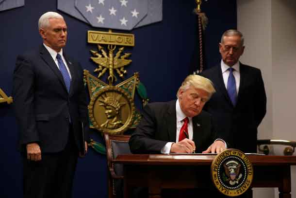 U.S. President Donald Trump signs an executive order he said would impose tighter vetting to prevent foreign terrorists from entering the United States at the Pentagon in Washington, U.S., January 27, 2017. REUTERS/Carlos Barria