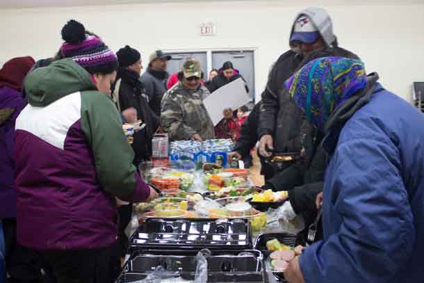 Community members in Washaho Cree Nation / Fort Severn enjoy tasty snacks
