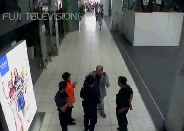 A still image from a CCTV footage appears to show a man purported to be Kim Jong Nam talking to security personnel, after being accosted by a woman in a white shirt, at Kuala Lumpur International Airport in Malaysia on February 13, 2017. FUJITV/via Reuters TV.