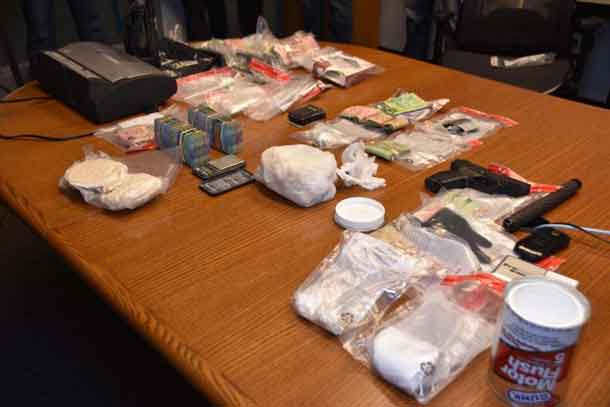 Thunder Bay Police image showing cash, replica firearm, drugs and other items seized