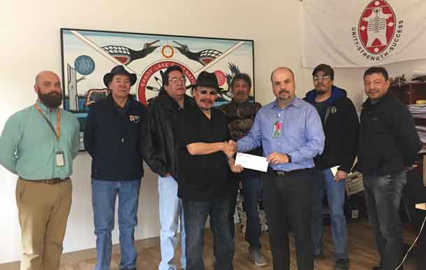 Perimeter Executives presenting $50K cheque to Chief Bart Meekis and Council. L. to R. Perimeter Cargo Operations Manager Andrew Fast, Deputy Chief Robert Kakegamic, Councillor Allen Rae, Chief Bart Meekis, Councillor Dennis Kakegamic, Perimeter Vice-President Commercial Services Carlos Castillo, Councillor John McKay and Councillor Russell Kakepetum