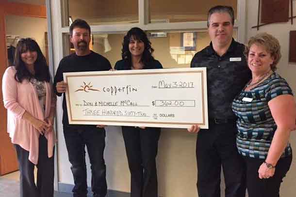 Don and Michelle McCall receive their dividends at the Copperfin Algoma Branch