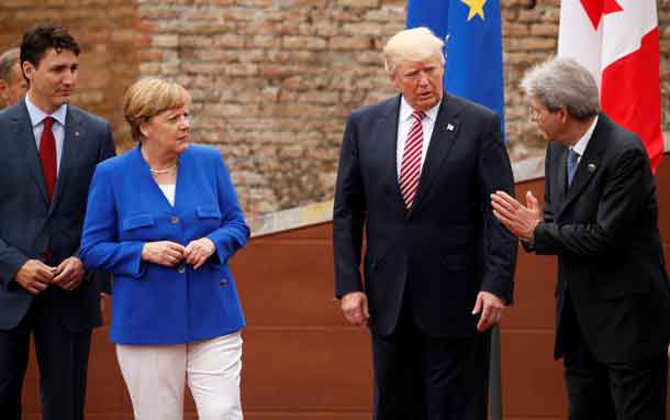 Italy's Prime Minister Paolo Gentolini (R) talks to Canada's Prime Minister Justin Trudeau (L), German Chancellor Angela Merkel and U.S. President Donald Trump while posing for a family photo at the start of G7 Summit at Greek Theatre in Taormina, Sicily, Italy, May 26, 2017. REUTERS/Jonathan Ernst
