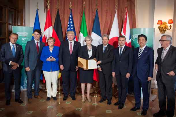 European Council President Donald Tusk, Canadian Prime Minister Justin Trudeau, German Chancellor Angela Merkel, U.S. President Donald Trump, Britain’s Prime Minister Theresa May, Italian Prime Minister Paolo Gentiloni, French President Emmanuel Macron, Japanese Prime Minister Shinzo Abe, and European Commission President Jean-Claude Juncker pose after signing the 'G7 Taormina Statement on the Fight Against Terrorism and Violent Extremism' at the G7 summit in Taormina, Sicily, Italy, May 26, 2017. Guido Bergmann/Courtesy of Bundesregierung/Handout via REUTERS