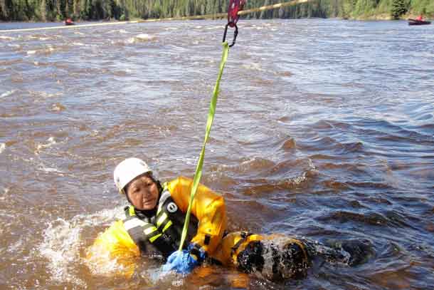 Master Corporal Kathleen Beardy of Muskrat Dam clutches a carabiner clip attached to a rescue rope during swift water rescue training. Credit: Warrant Officer Barry Borton