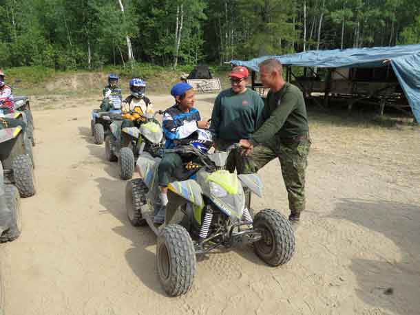 unior Canadian Ranger Chad Bottle takes last minute instructions from Master Corporal Sherrie Kakekespan and Sergeant Kevin Meikle before beginning a challenging cross country ATV ride.  credit Sergeant Peter Moon, Canadian Rangers