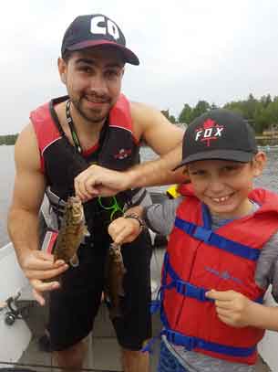 Companion Ben (left) and Camper Denver holding the fish they caught!